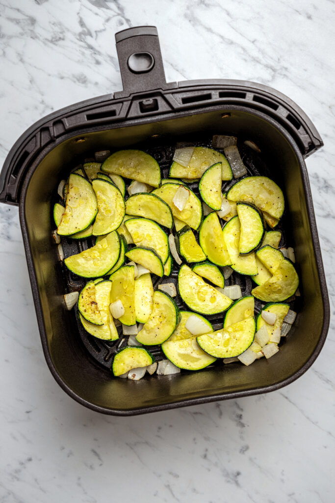 Cooked zucchini and onion in an air fryer.