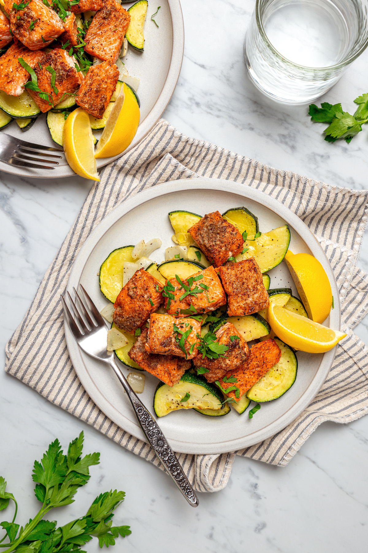 A homemade air fryer salmon recipe with Cajun spices and zucchini.