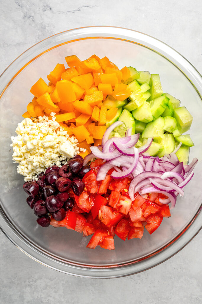 Salad ingredients combined in a large bowl.