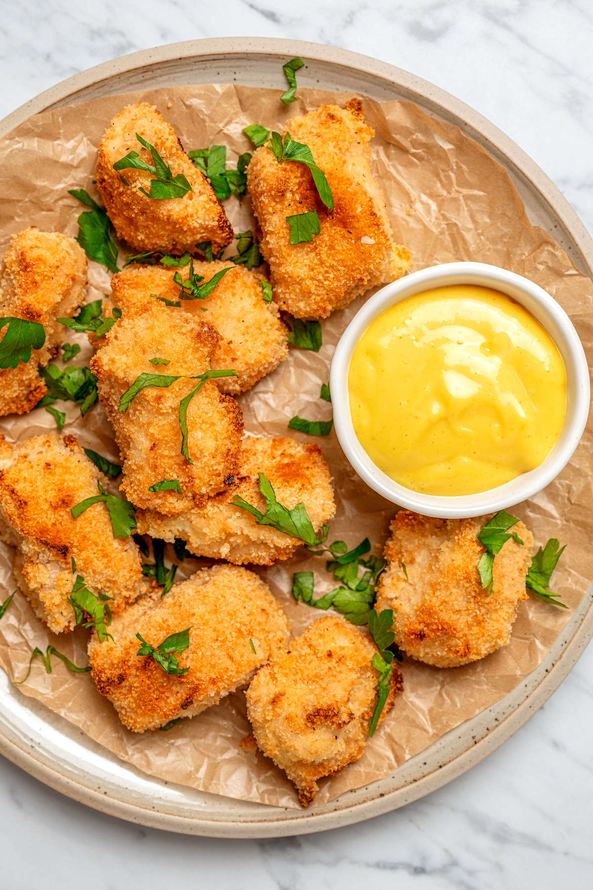 Close-up of crispy baked chicken with honey mustard.