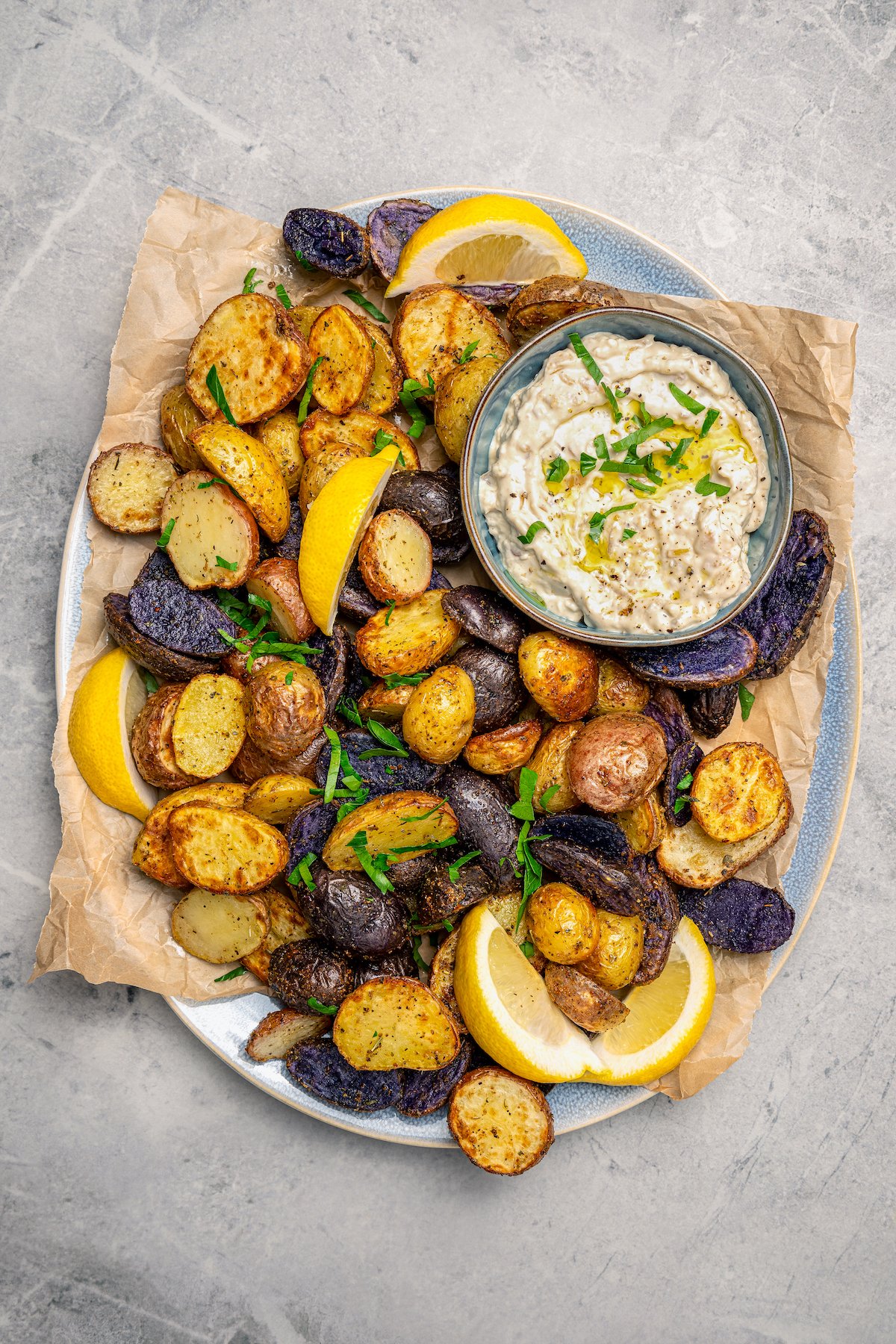 Air fryer mini potatoes in a plate with a dipping sauce. 