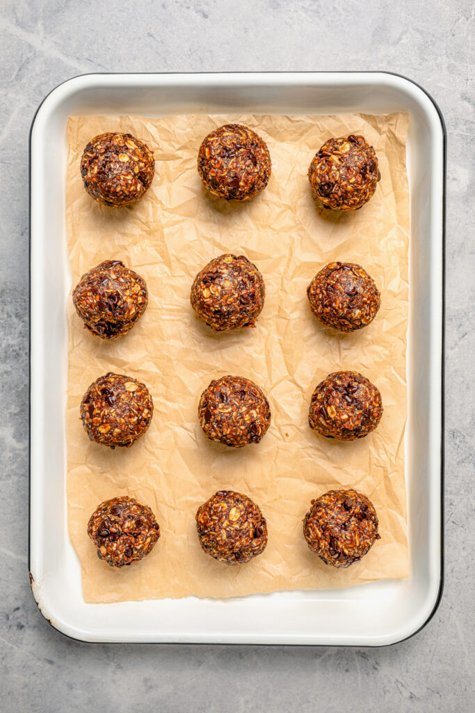 Rolled energy balls on parchment paper.