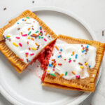 Protein pop tarts with frosting cut in half.