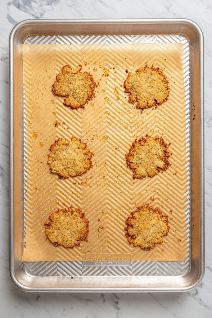Baked cauliflower chips in the baking sheet. 