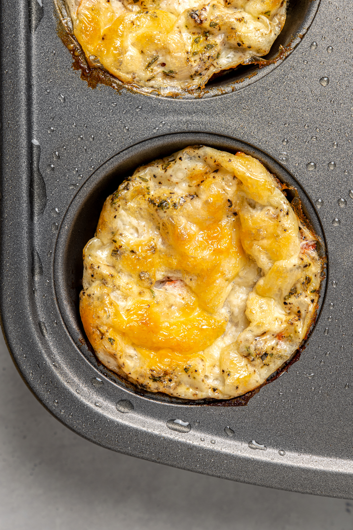 Close-up of an egg bite in the muffin tray. 