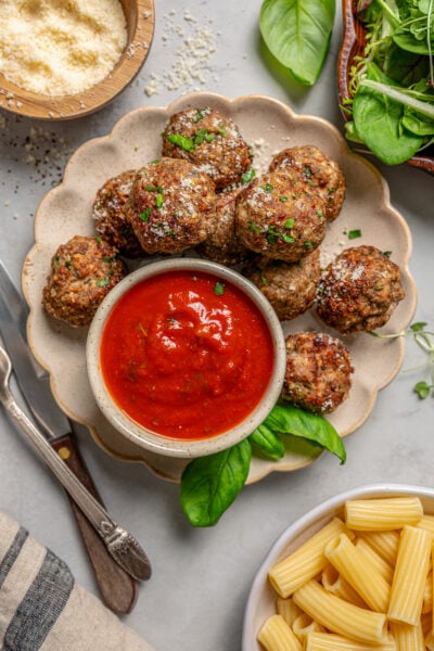 Plate of air fryer meatballs with dipping sauce on the side.